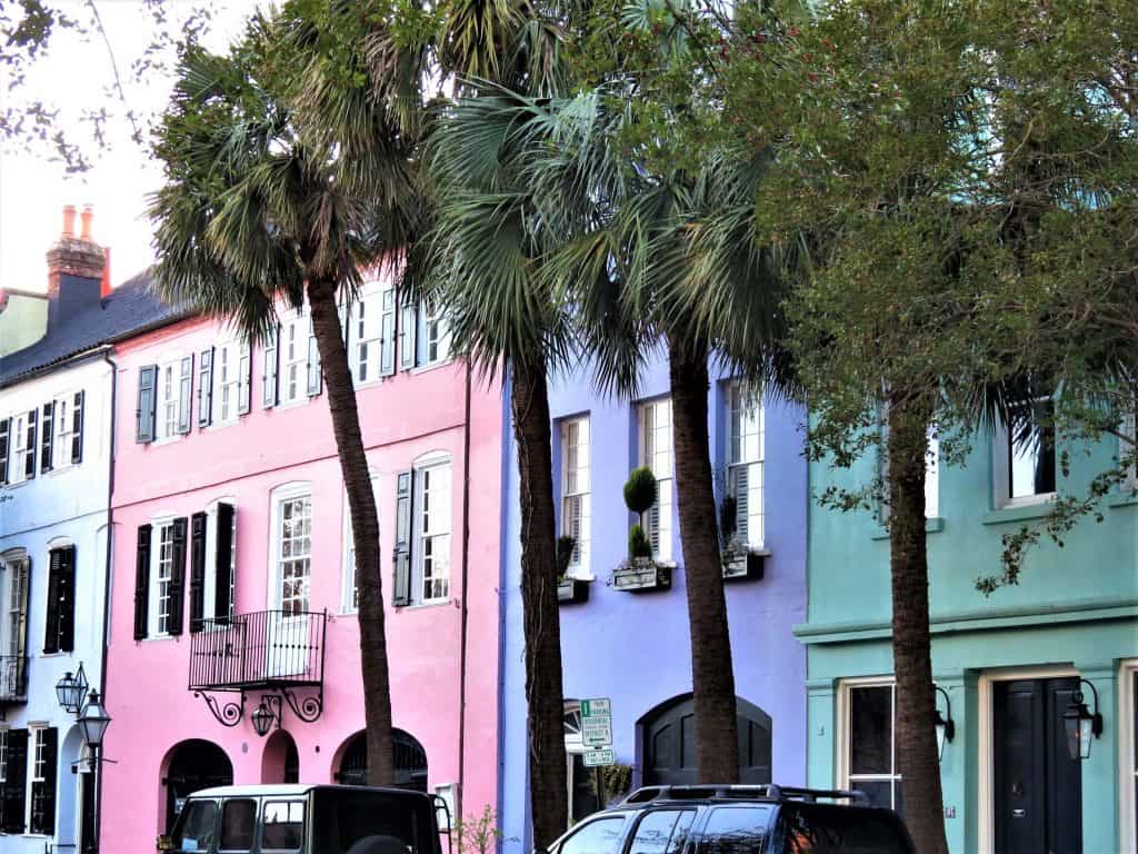 Charleston's famous rainbow row is a blue, pink, purple, green, and yellow house side by side.