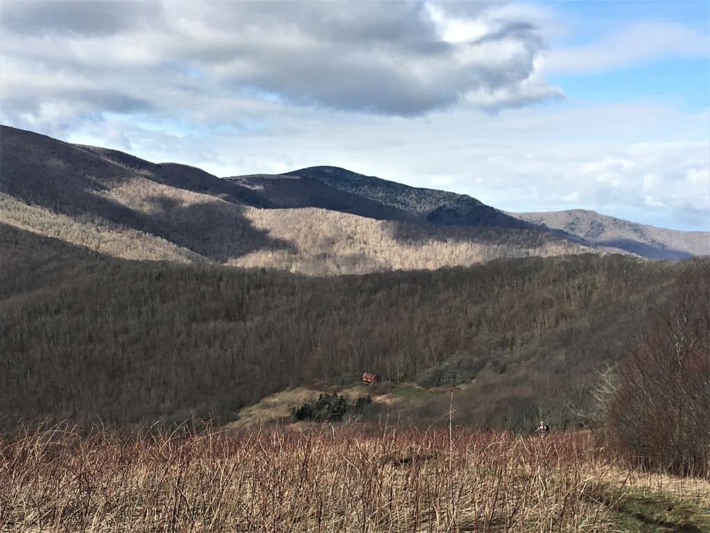 Winter view looking back at Overmountain Shelter from halfway up Yellow Gap with almost no grass and a clear view of the shelter.