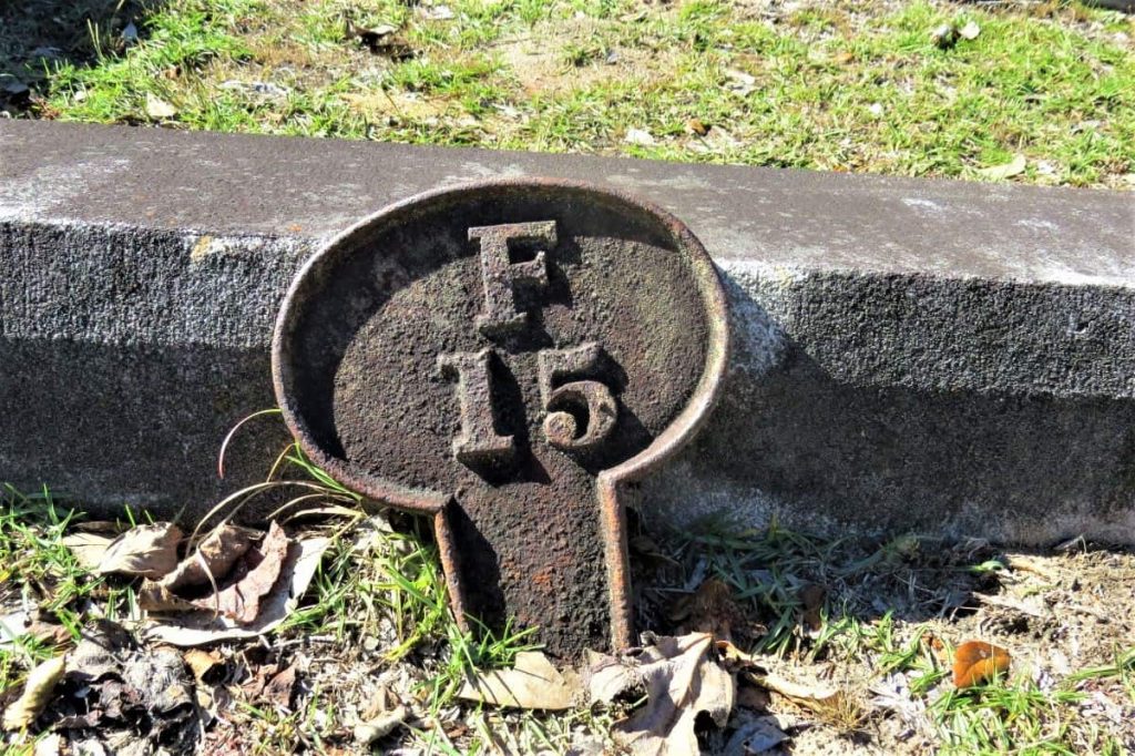 Each gravesite has an "address" which are denoted by metal tags. This one is F15.