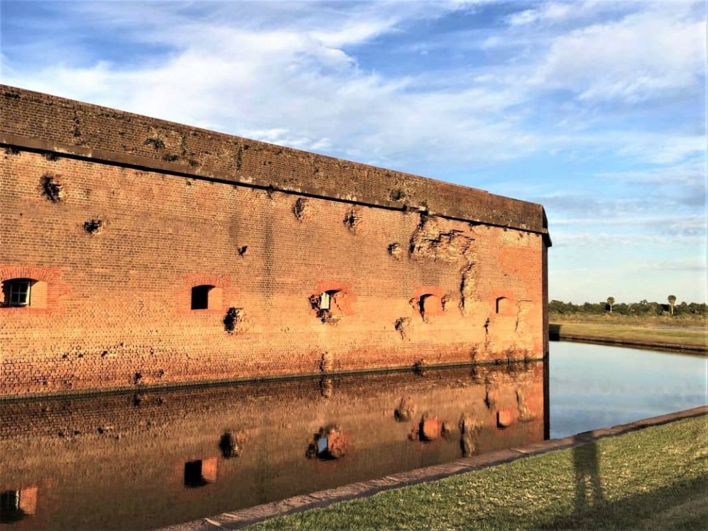 Side of Fort Pulaski with holes and dents from mortar fire.
