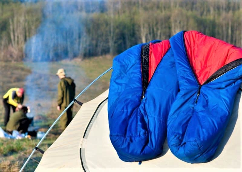 Sleeping bags laid on top of tent in the sun to dry.