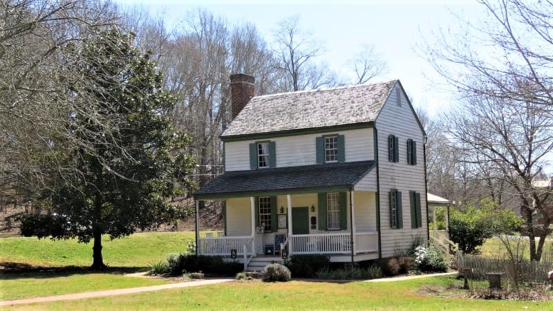 White farmhouse with green shutters that serves at the Hillsborough Visitor Center.