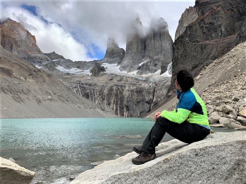 Author sitting by the green lake and looking at the 3 peaks known as the Torres.