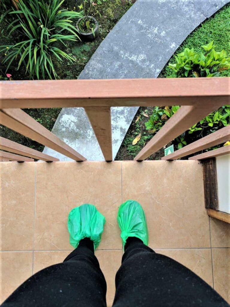 Author's feet wrapped in green plastic bags to help keep her feet dry.