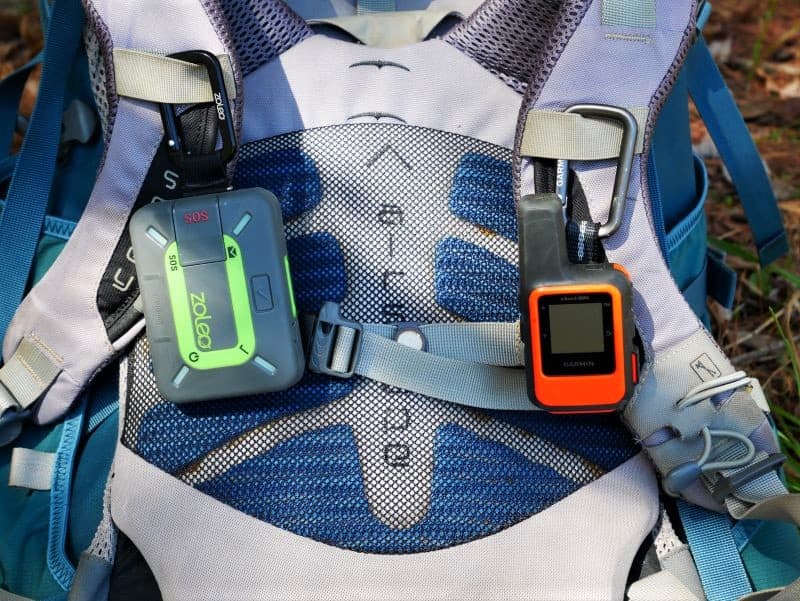 Zoleo and inReach Mini attached to harness on backpack for size comparison
