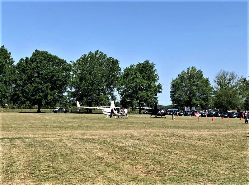Helicopters getting ready to take off with passengers to fly over the Pickle Festival.