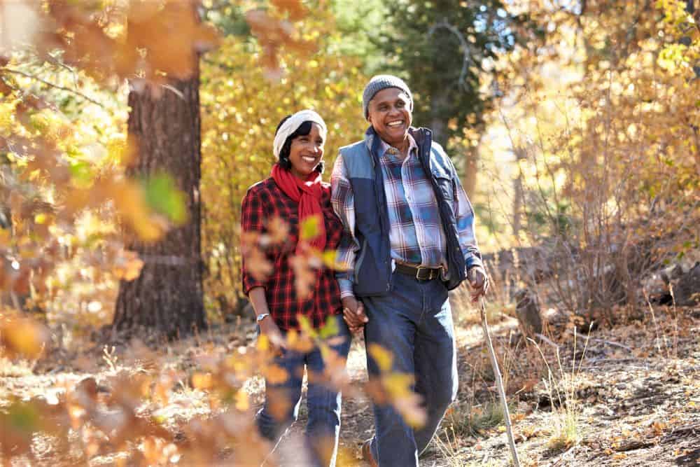 Couple hiking on a trail in the fall.