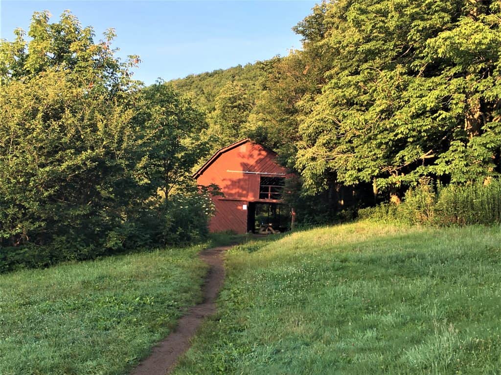 The iconic Overmountain Shelter. A two story red barn on the Appalachian Trail. 