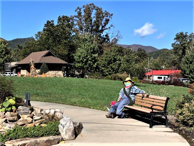 Black Mountain town square decorated for fall with a scarecrow on a bench.