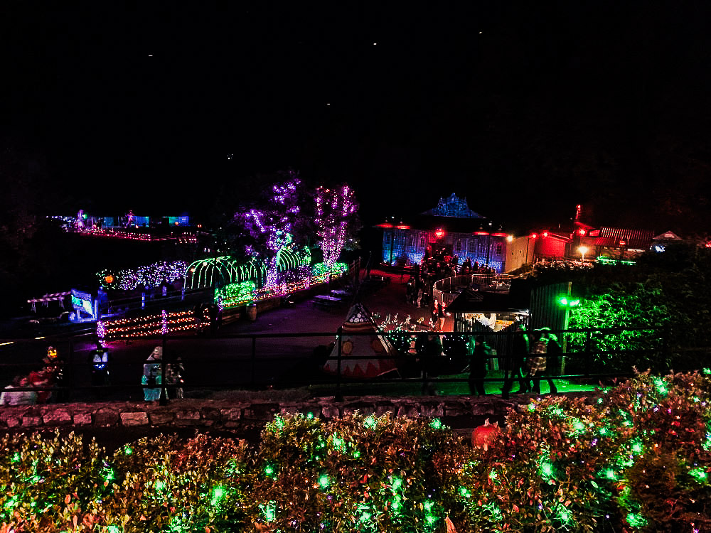 Overview of Tweetsie Ghost Train attractions highlighting Haunted House and green neon bridge. 