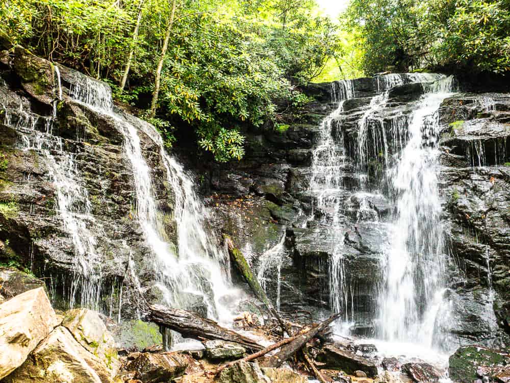 Two waterfalls at a 30 degree angle from each other. The water cascades down rock fronts. This is Soco Falls in Cherokee, NC. 